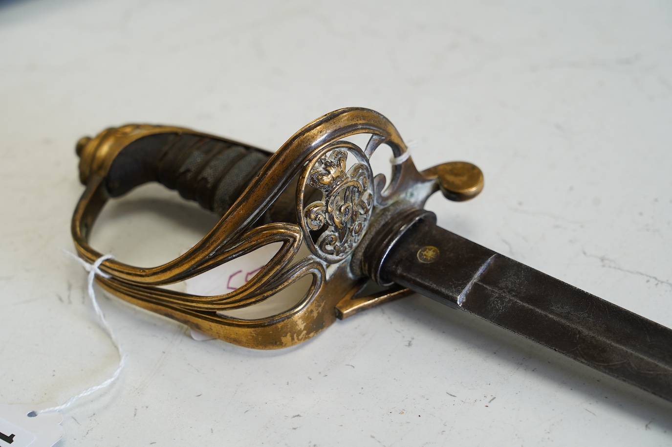 An 1845 infantry officer’s sword, with engraved, fullered and proofed blade, brass guard and remains of shagreen grip, blade 80.5cm. Condition - fair, well worn